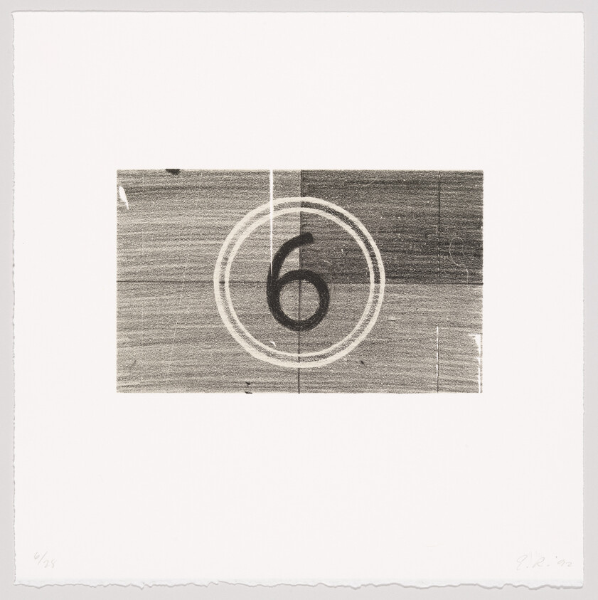 A printed film countdown frame showing a large number 6 inside concentric circles.