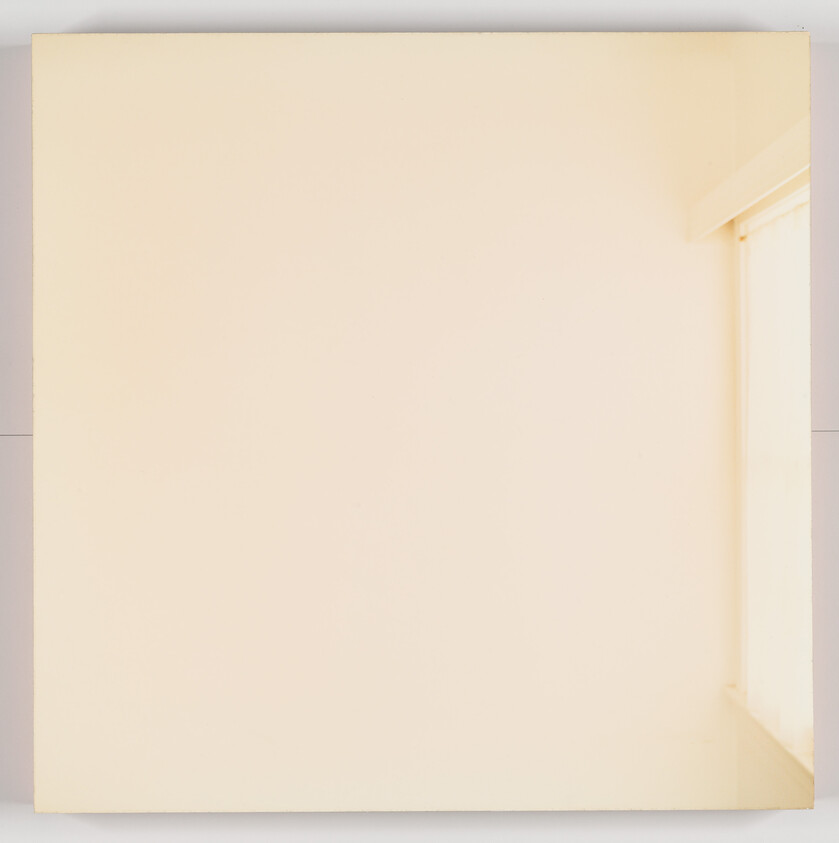 A minimalist image showing a plain, light-colored wall with a subtle shadow in the corner, suggesting a room corner with a window just out of view to the right.