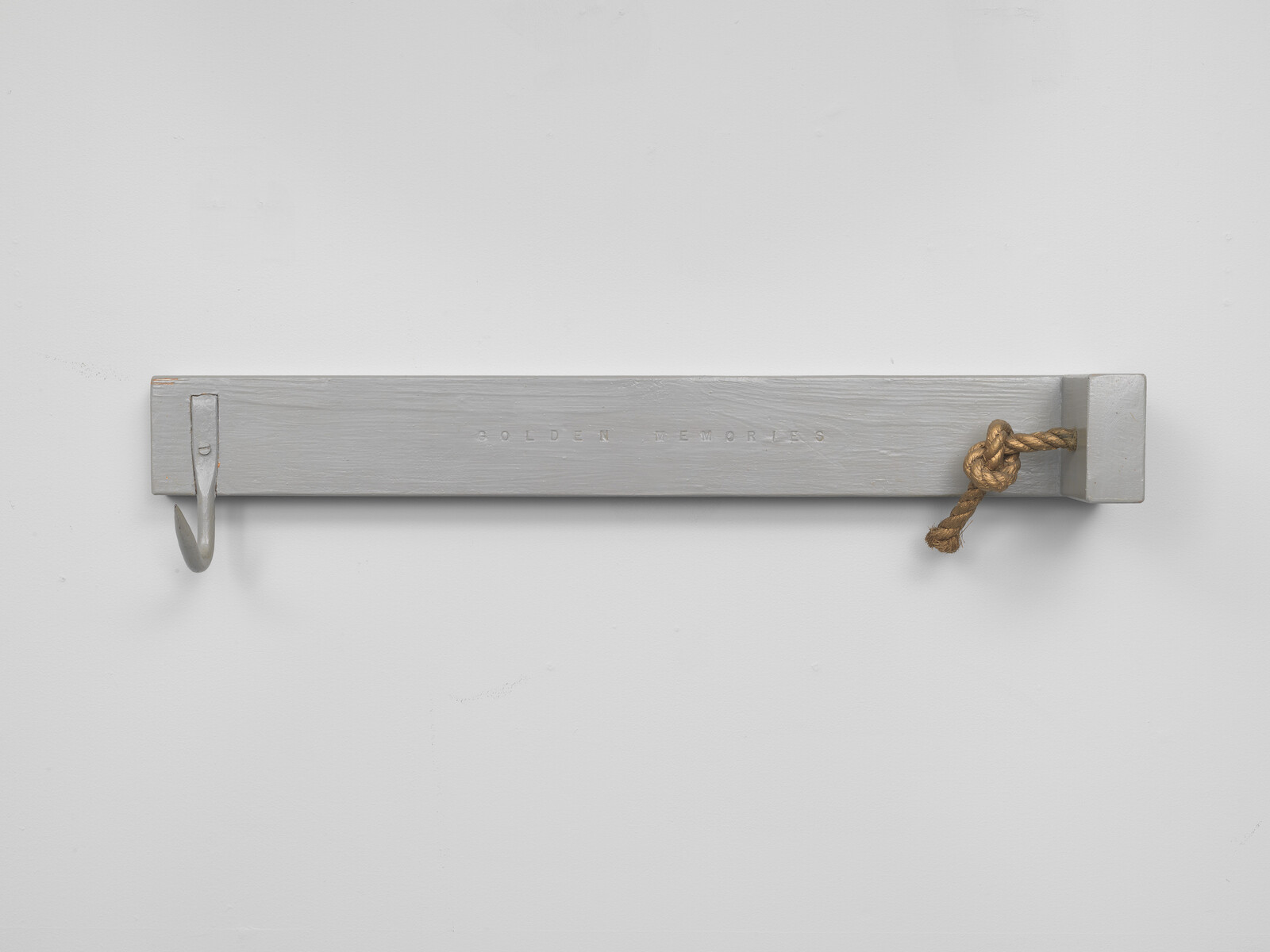 A gray wooden wall rack with a single metal hook on the left and a knotted rope on the right.