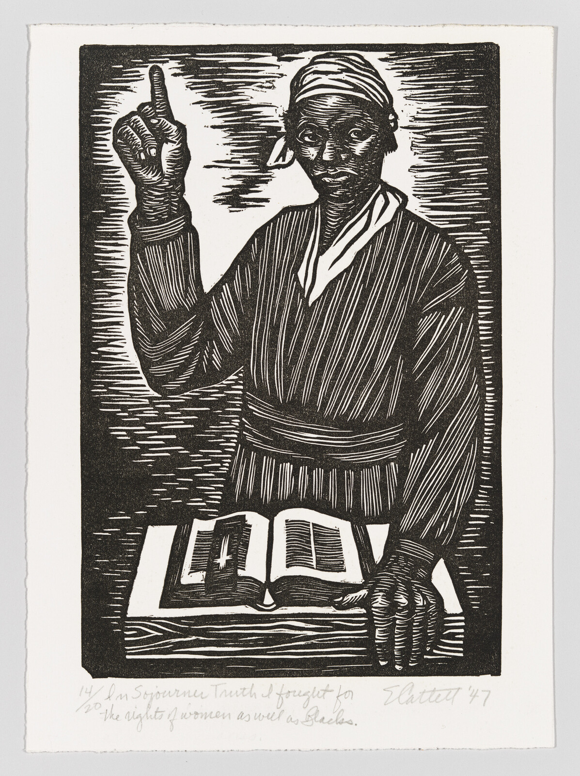 Sojourner Truth pointing upwards with her right hand and holding a table containing a bible with her left.