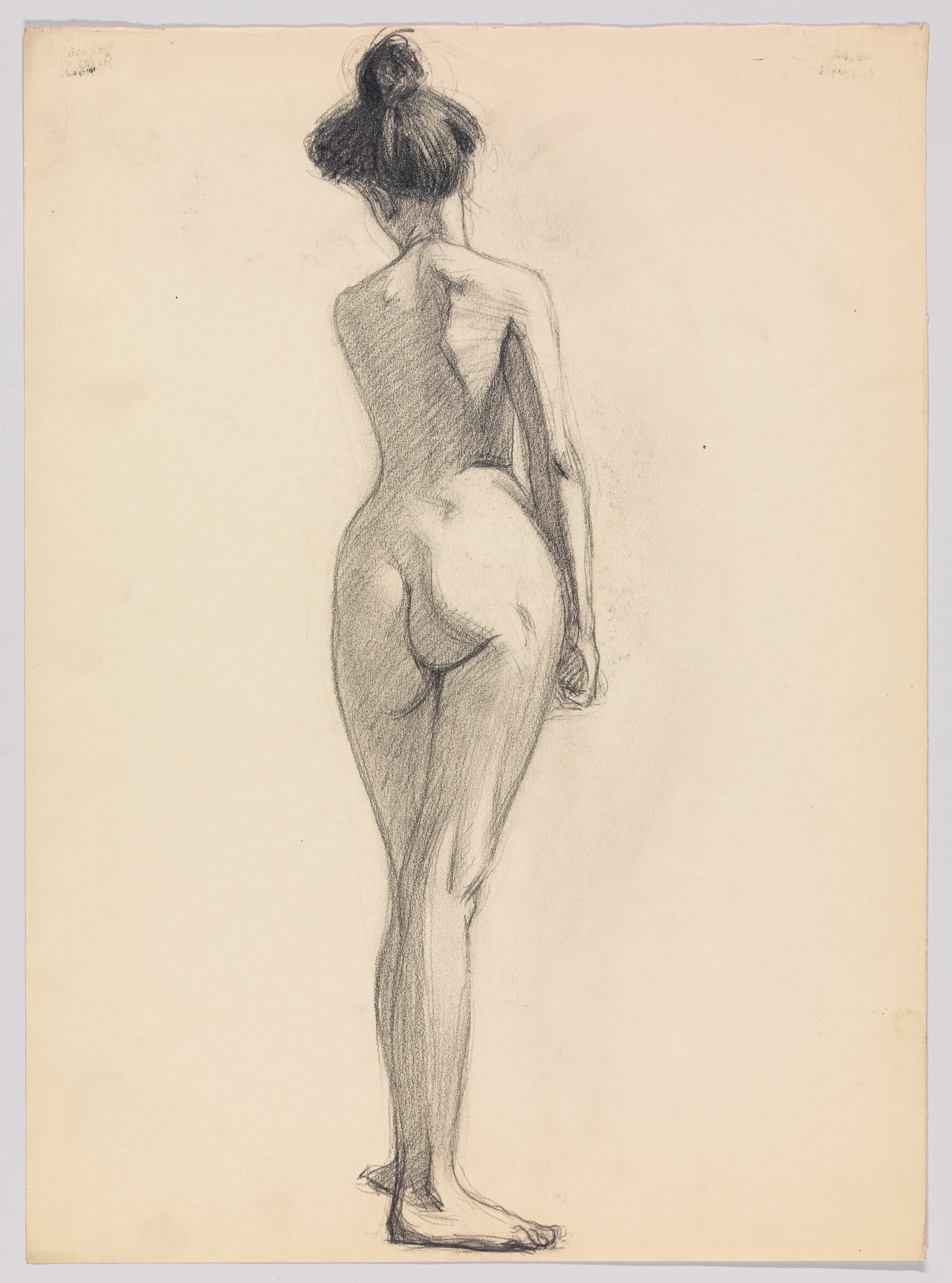 Nude woman standing in three-quarter back pose with hair in a bun, pencil sketch.