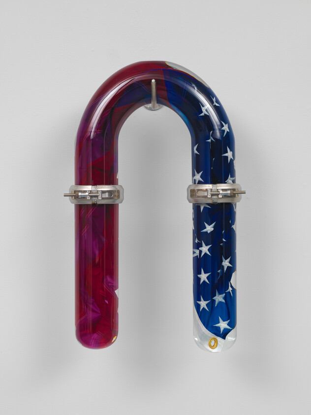 A U-shaped glass tube hangs on the wall, one side red-purple and the other blue with white stars.