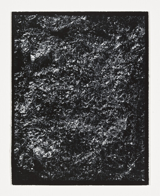 Crinkled dark metallic foil fills a rectangular frame with high-contrast shiny and matte textures.