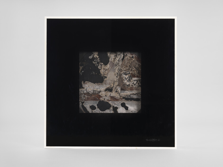 Framed square artwork with black mat and textured abstract center panel in earth tones.