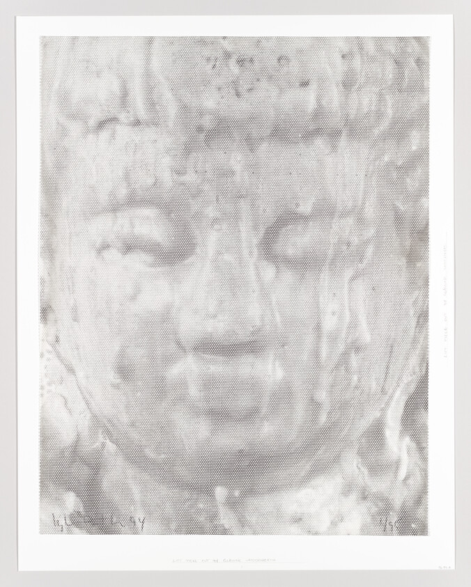 Close-up of a serene Buddha face made with a halftone dot pattern.