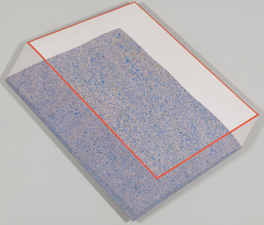 A folded speckled blue sheet partially covered by a red-outlined white rectangle.