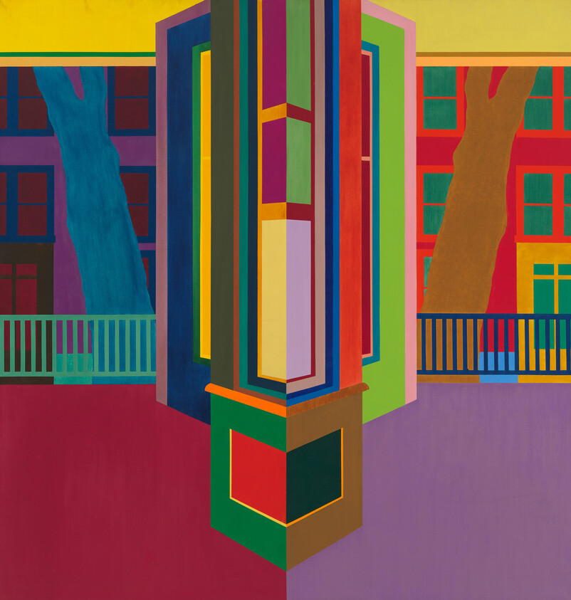 A vibrant geometric building corner with multicolored panels, flanked by trees and railings.