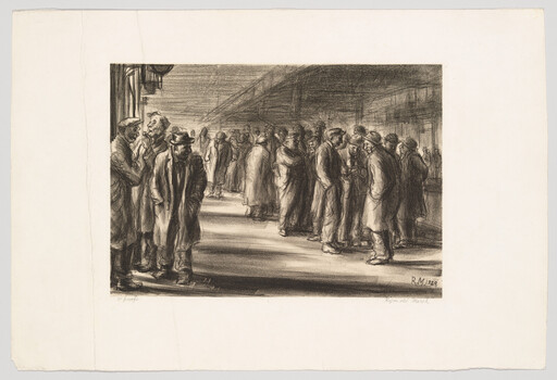 Men gathered on a dim train platform, standing in small groups and talking.