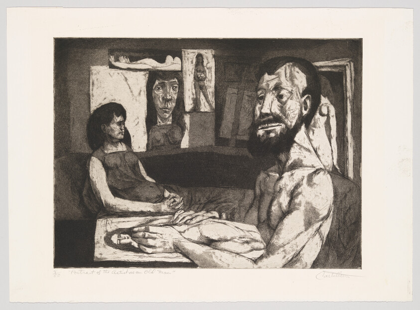 Bearded man sits shirtless at a table with a seated woman and portraits on the wall.