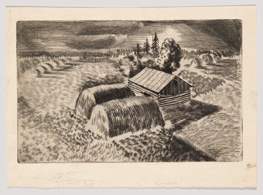 A small wooden barn beside two large rounded haystacks in a harvested field with trees.