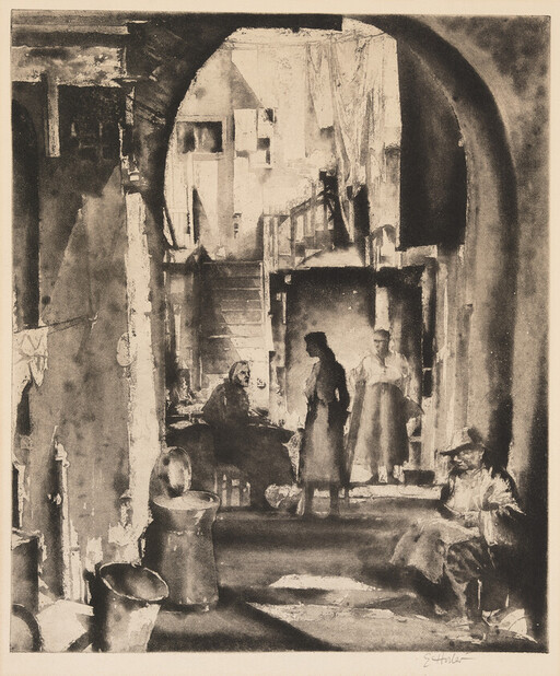 Group of people gathered in a dim, arched interior courtyard, two women talking near seated figures.