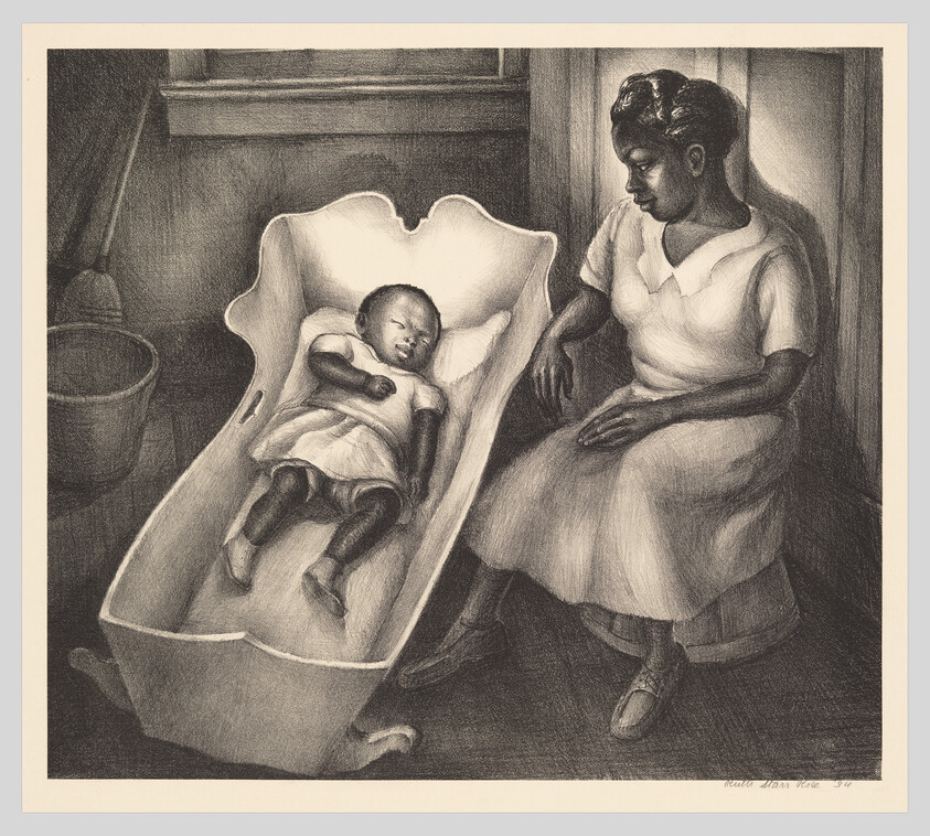 A woman sits beside a sleeping baby resting in a shallow wooden cradle, watching over the child.