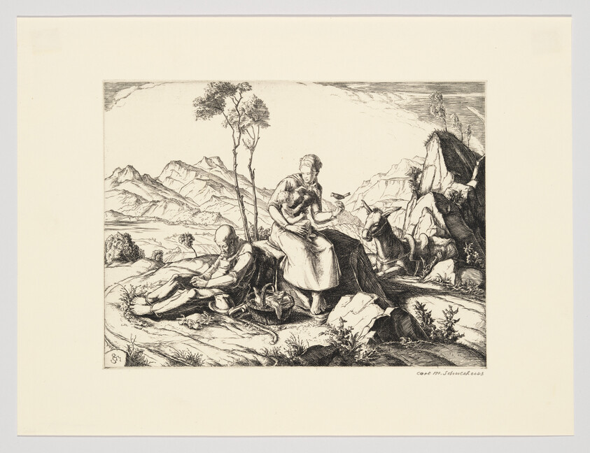 A woman holds a child while a man sleeps on the ground near goats in a mountain landscape.