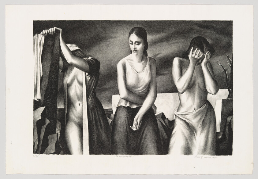 Three women stand on a rocky shore with one covering her face and another pulling cloth.