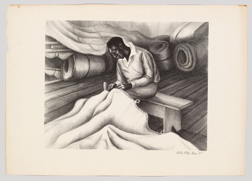 A man sits on a bench sewing large sailcloth under rolled fabric in a dim workshop.