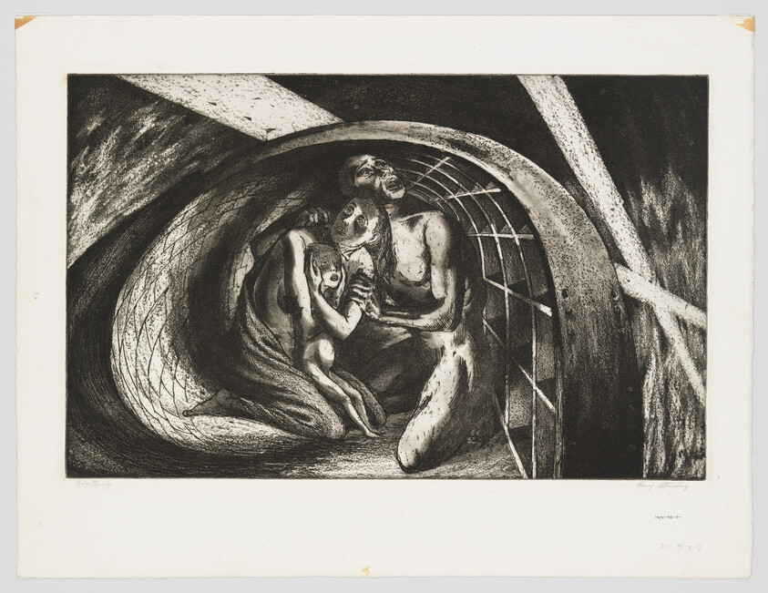 A terrified family huddles together inside a dark, curved tunnel shelter.