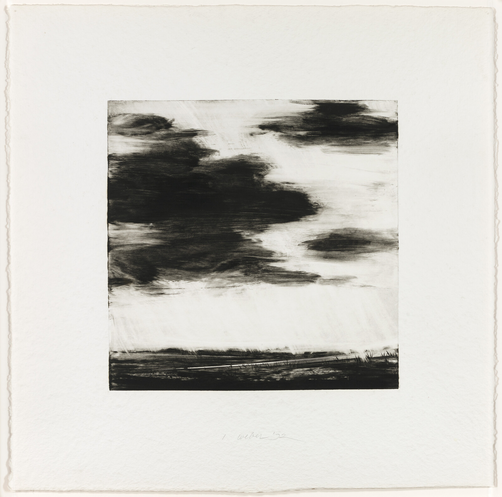 Dark, sweeping clouds move across a flat coastal landscape with distant shoreline.