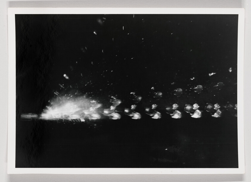 A high-speed sequence shows a bullet shattering and its fragments traveling across a dark background.