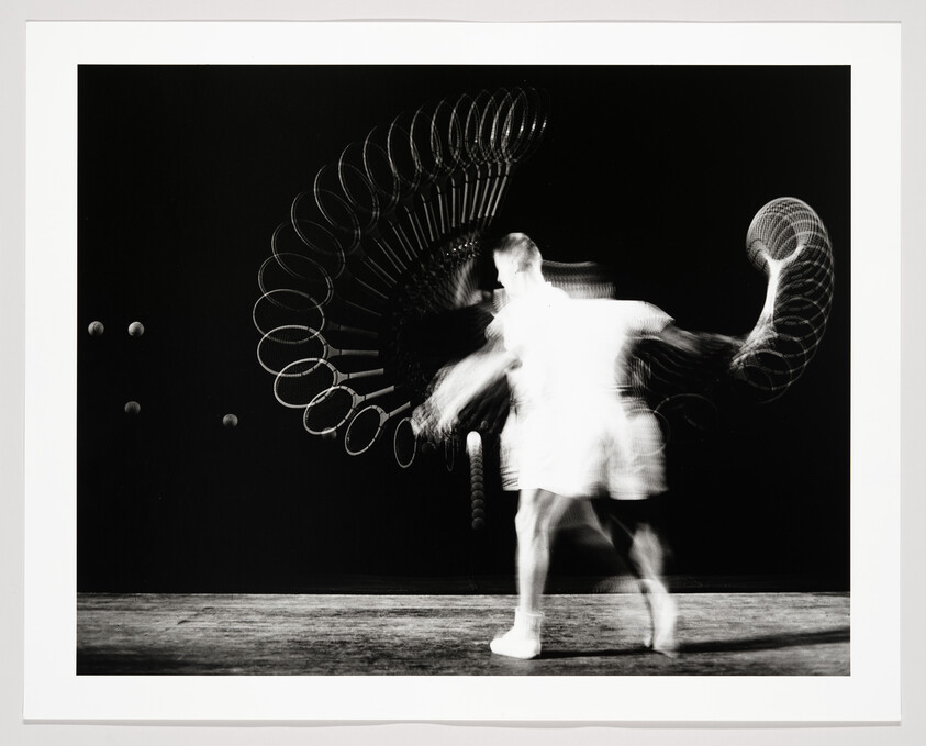 A blurred person swings a skipping rope, creating overlapping circular motion trails.