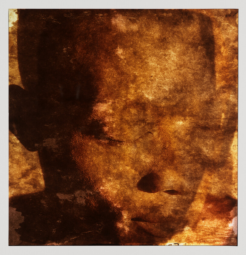 Close-up of a child's face with closed eyes in warm brown textured tones.