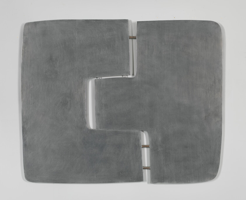 Two large gray metal panels with interlocking cutouts connected by three visible coil springs.