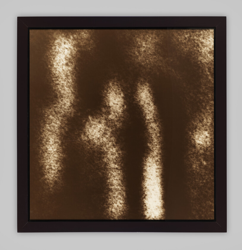 Framed abstract brown and beige artwork with soft vertical light streaks and textured pattern.