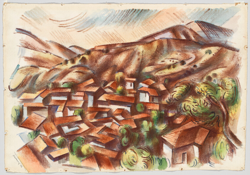 A small village with red roofs nestled among trees at the base of rolling brown hills.