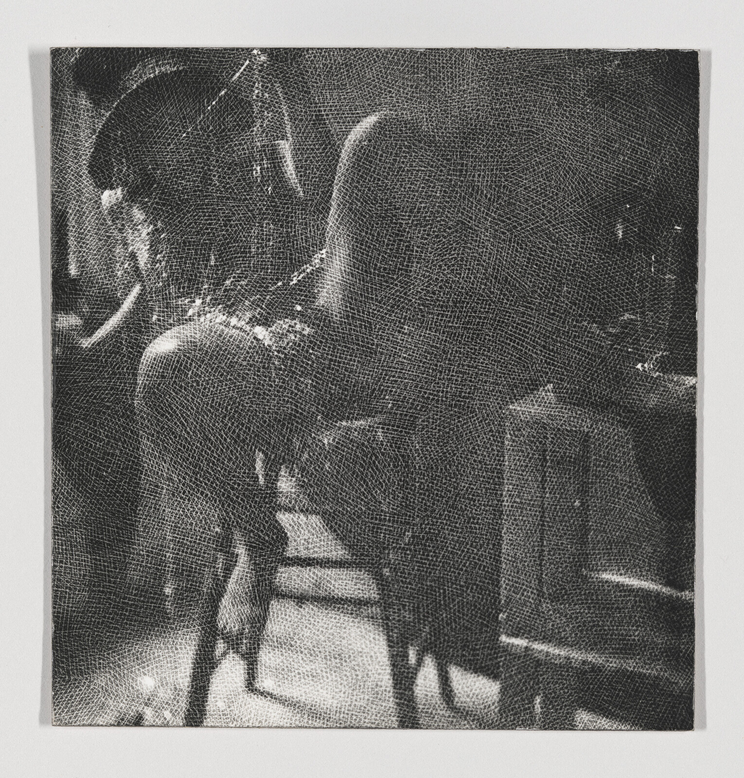 A chair draped with a coat sits in a dimly lit room beside another empty chair.