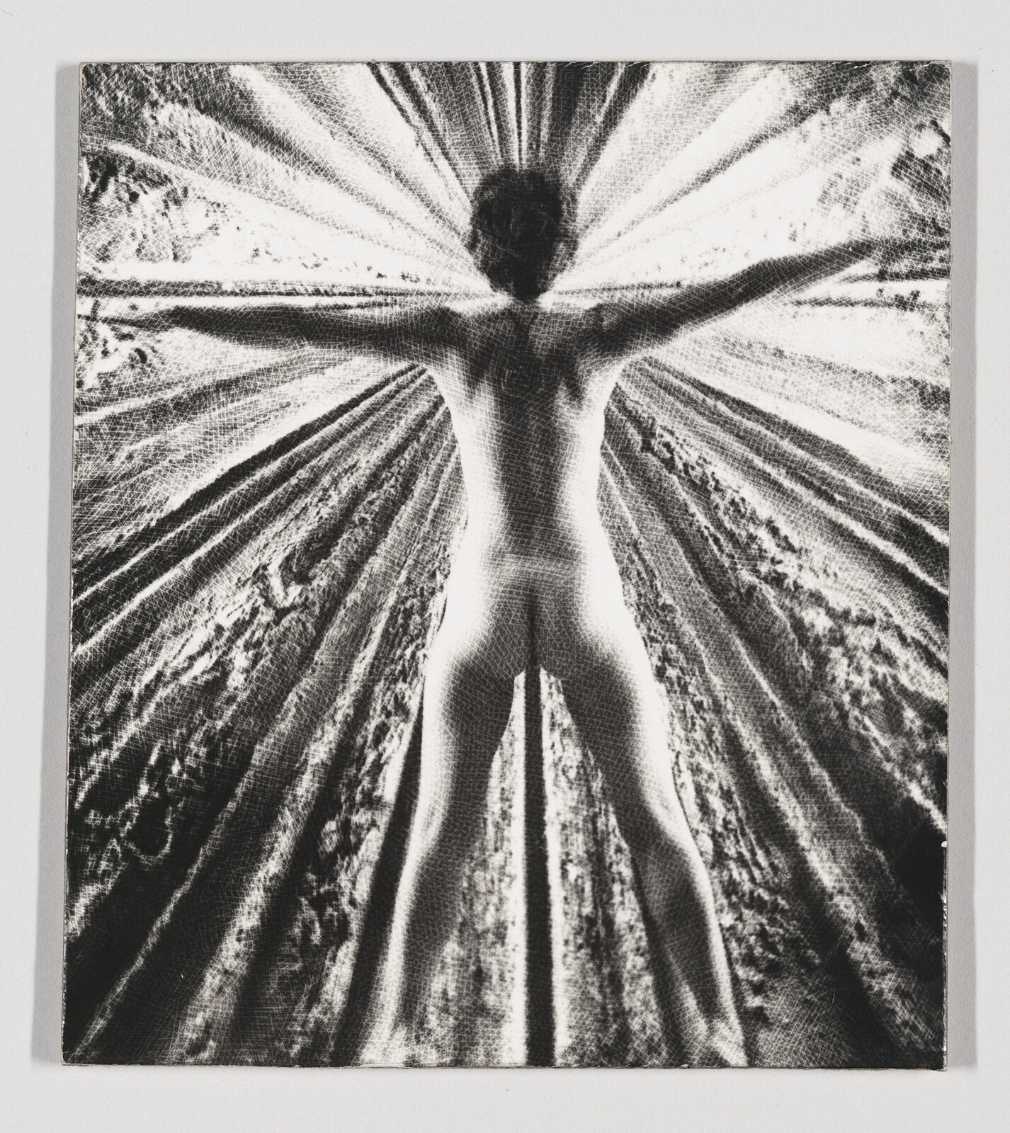 Person standing with arms and legs outstretched, creating a starburst pattern in a textured background.