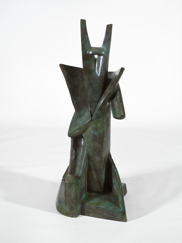 Tall abstract bronze sculpture with angular geometric shapes resembling a stylized standing figure.