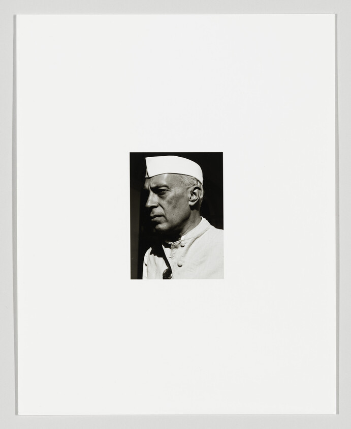Black and white profile portrait of a man wearing a chef's hat, set against a white background with a wide border.