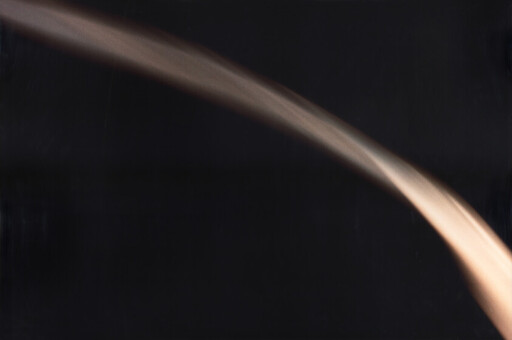 A soft warm streak of light sweeps in a curved arc across a dark background.