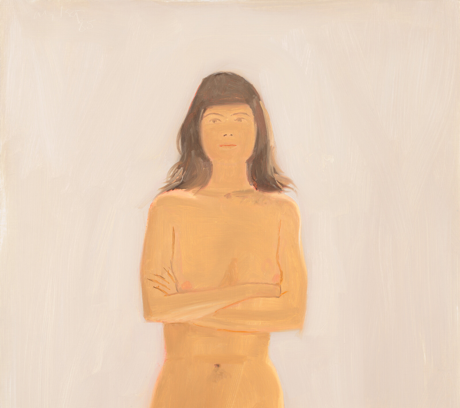 A topless young woman stands with arms crossed looking straight ahead against a pale background.