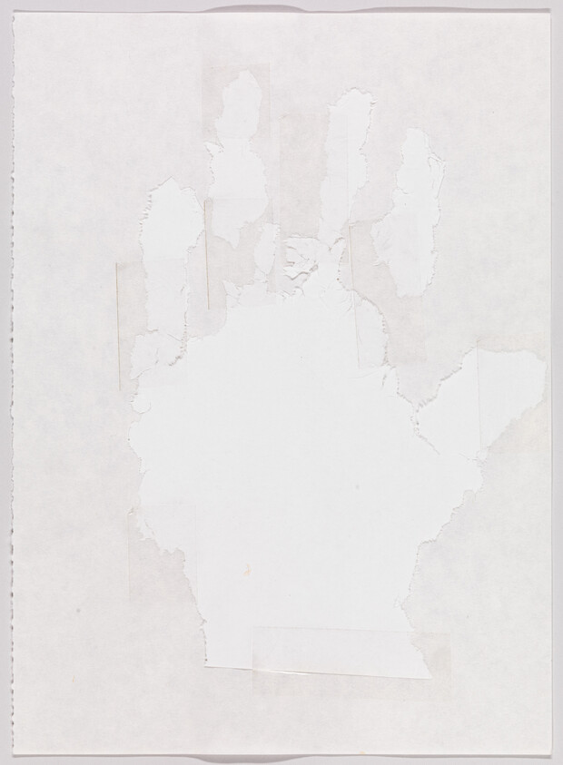 Torn paper left a rough hand-shaped outline on a white sheet with tape marks.