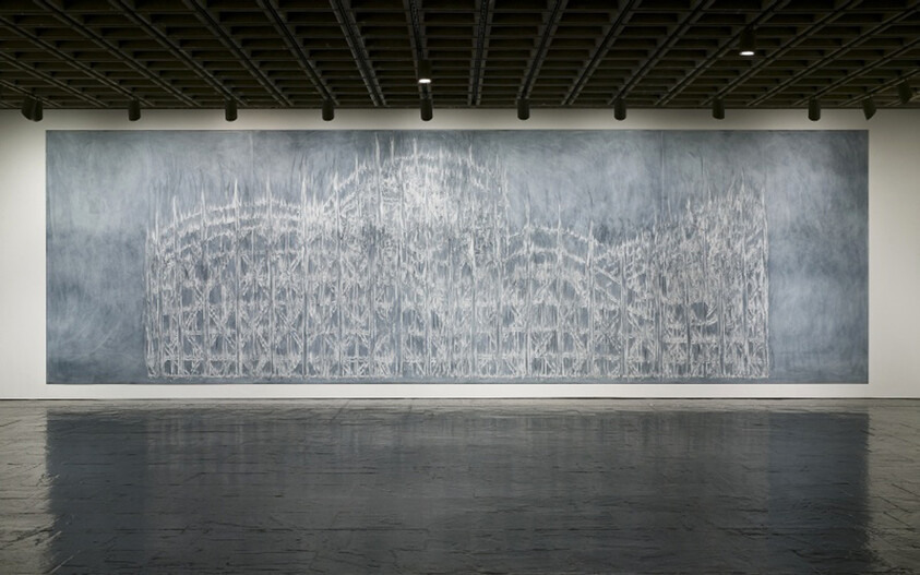 Large gray and white abstract mural resembling a delicate architectural framework hangs on a gallery wall.