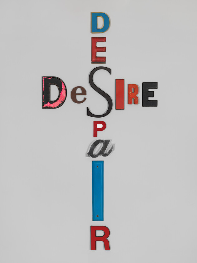 Letters arranged in a cross spelling "desire" horizontally and "despair" vertically.