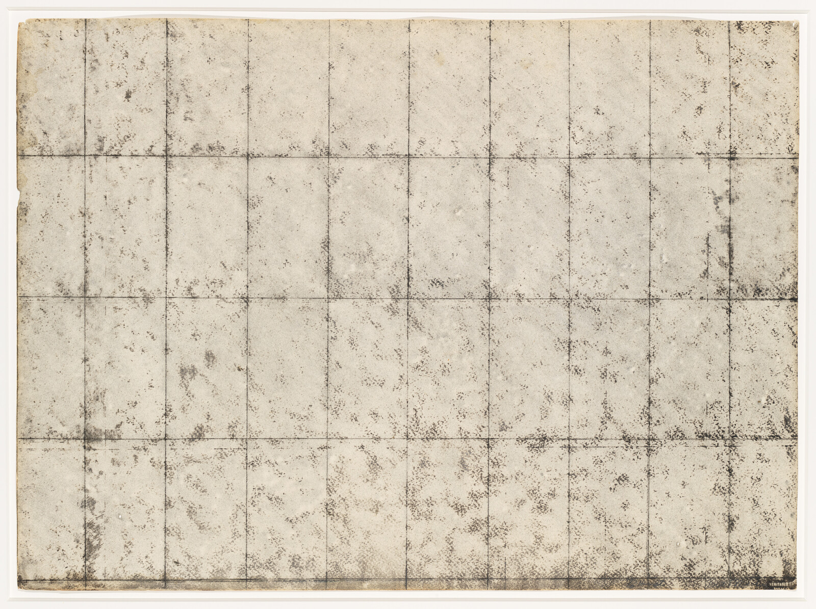 A worn, beige paper sheet marked by a faded grid of fold lines and dark stains.
