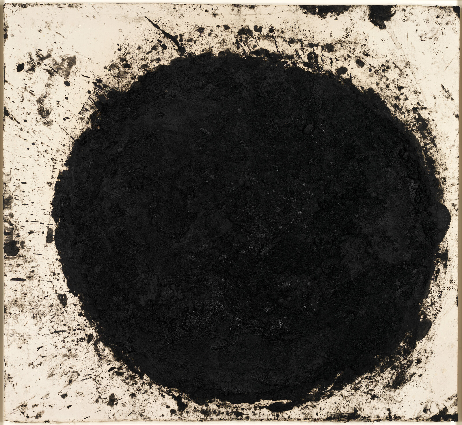 Large rough black circular paint mass with splattered edges on a white square background.