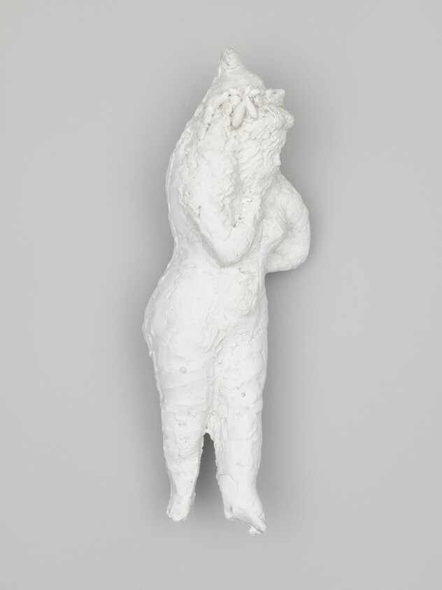 A textured white sculpture of a standing humanoid figure covering its face with hands.