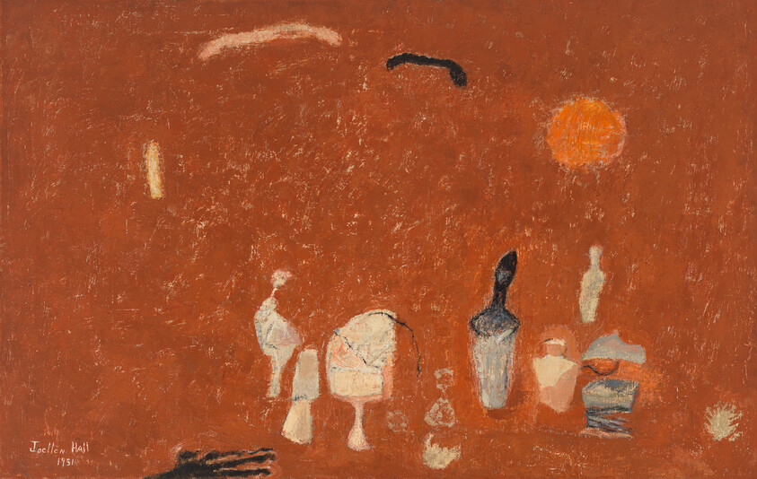 Several small abstract pottery shapes and a dark hand rest on a textured orange background.