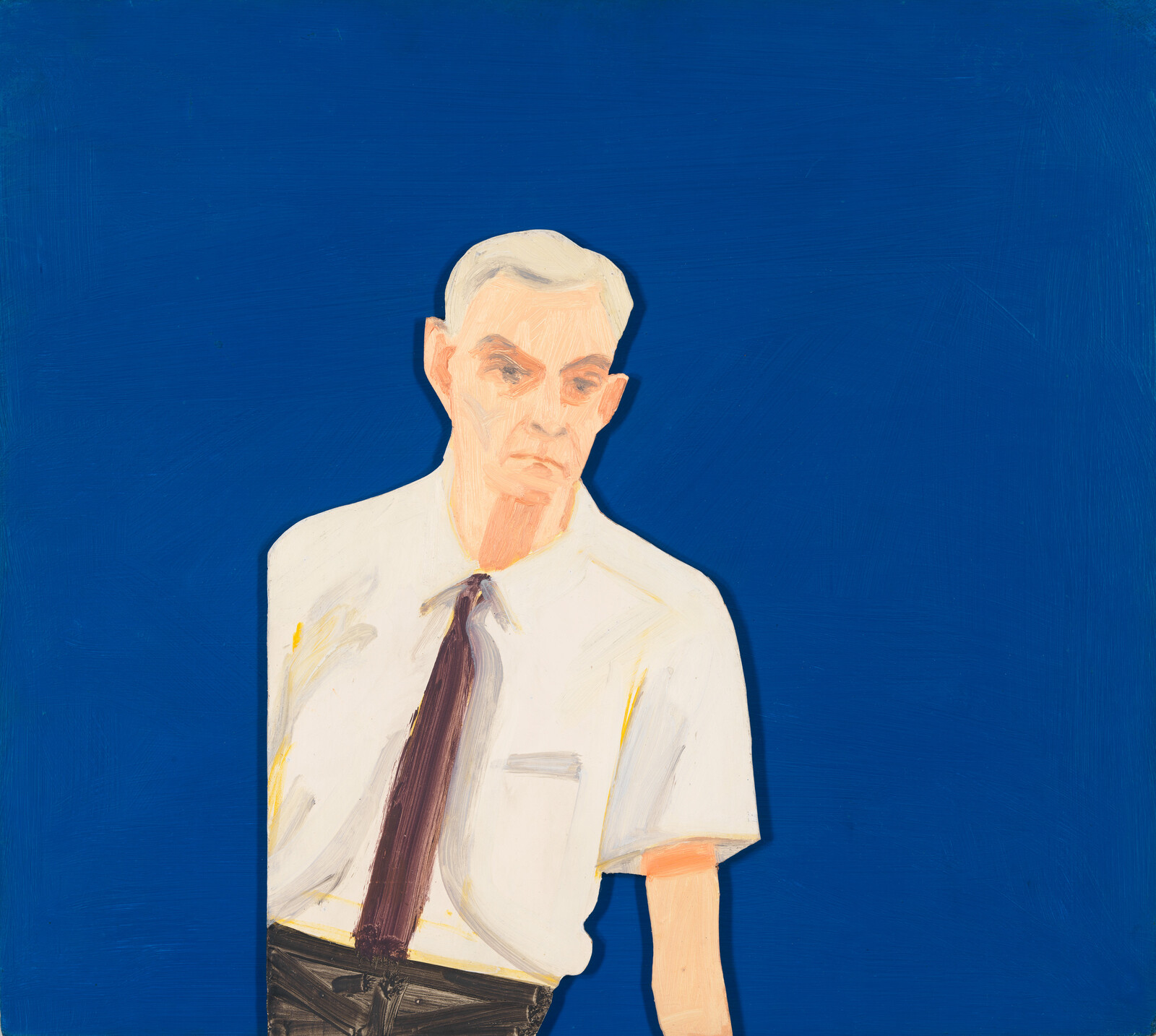 An older man in a white shirt and dark tie stands against a plain deep-blue background.