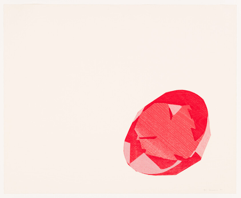 A faceted red gemstone sits on a plain white background near the lower right corner.