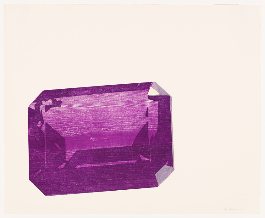 A large faceted purple emerald-cut gemstone rests on a pale background.