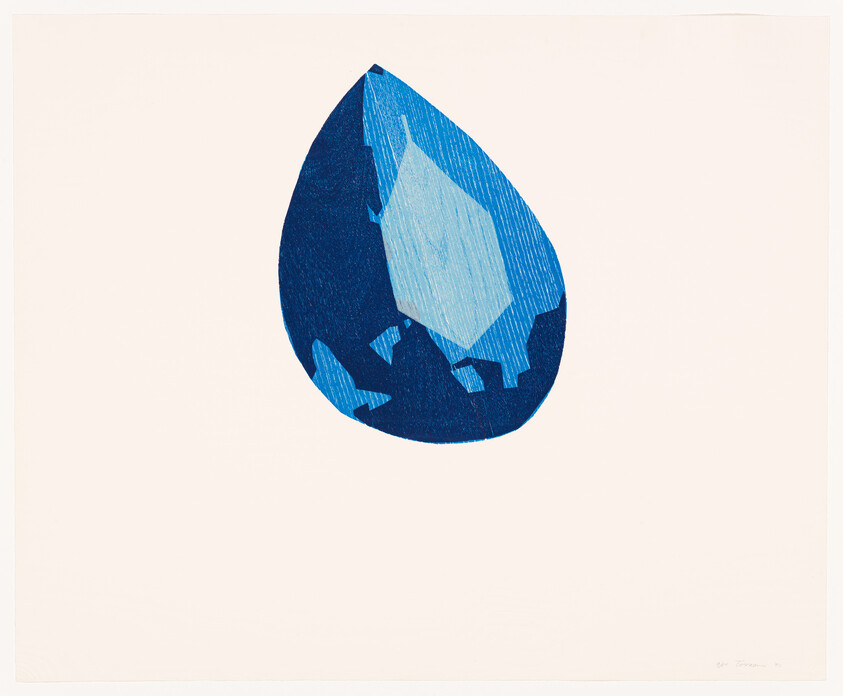 A large blue teardrop-shaped abstract gemstone with varying blue facets on a pale background.