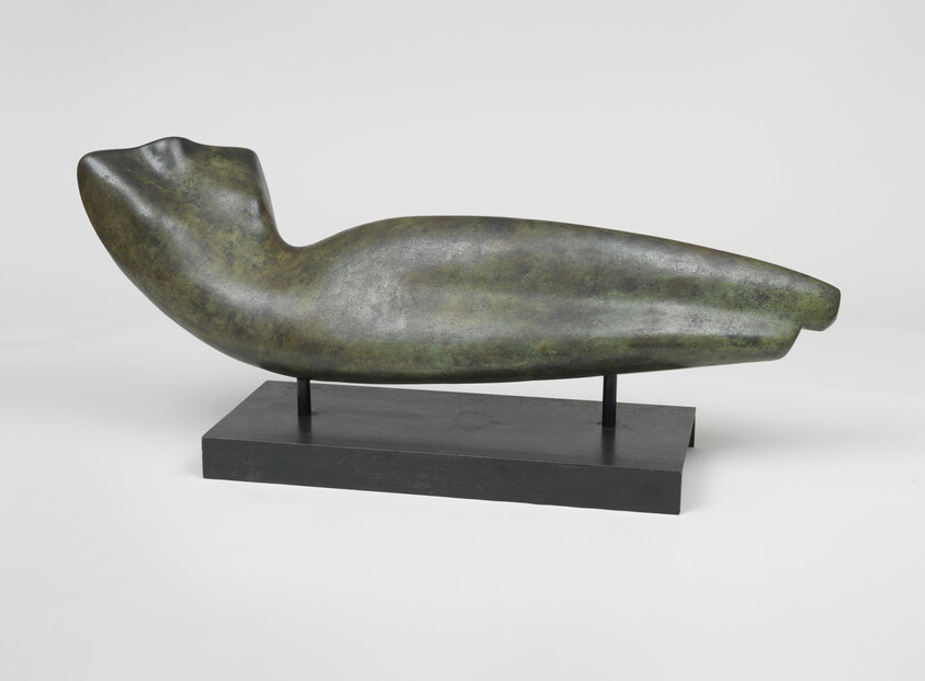 Abstract bronze reclining figure with smooth curved form mounted on a low rectangular black base.