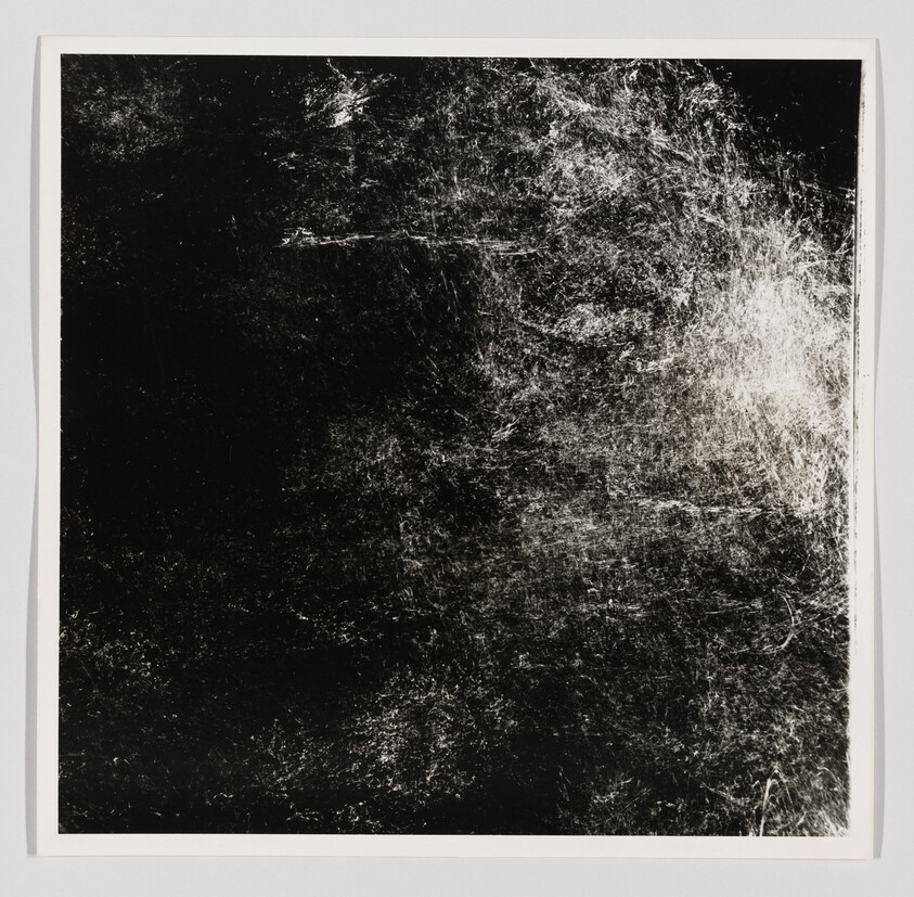 Black square artwork with dense white scratches and scuffed textures concentrated on the right side.