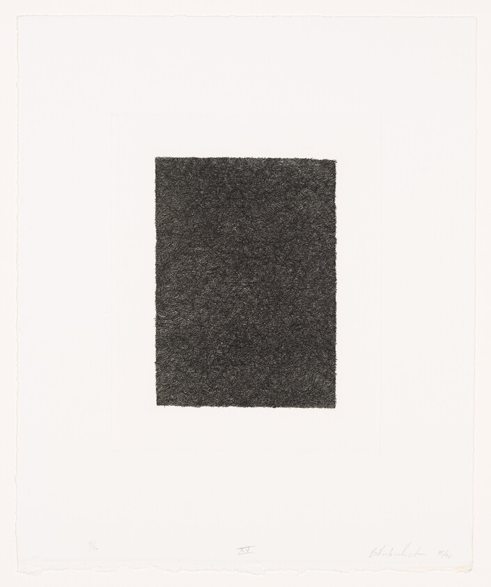 A dense, textured dark rectangle centered on a white sheet of paper.