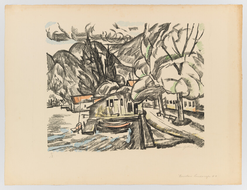 Small boats tied by a wooden dock beside houses and large trees along a calm shoreline.