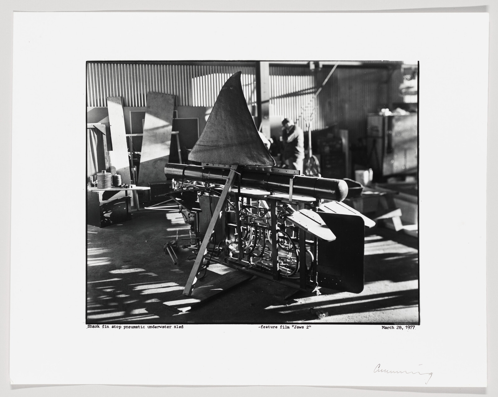 A large mechanical shark fin mounted on a pneumatic underwater sled labeled for the film "Jaws 2".