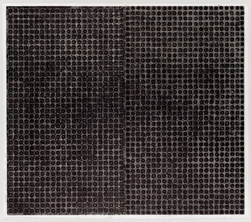 Dense grid of small dark circles forming two slightly different panels with worn, scratched surface.